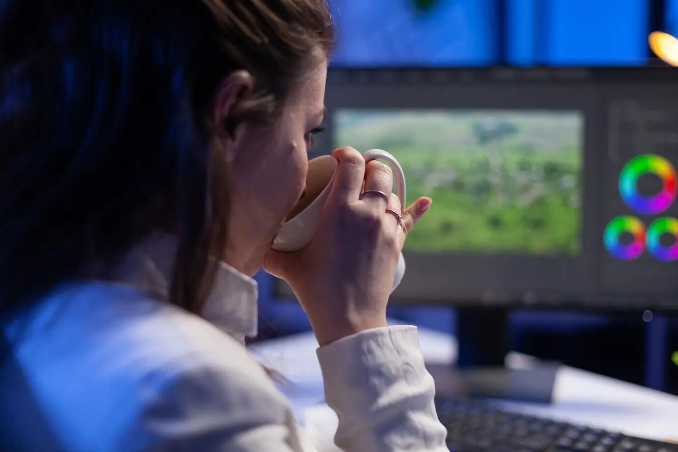 Konzentrierter Editor/Retuscheur bearbeitet das Color Grading an einem professionellen Computer.